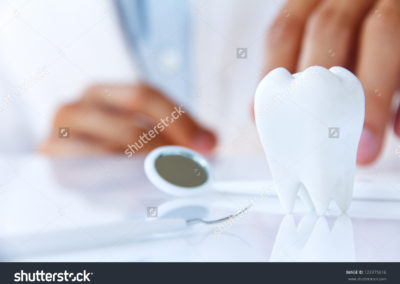 stock-photo-dentist-holding-molar-dental-concept-123375616