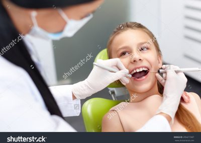 stock-photo-teeth-checkup-at-dentist-s-office-dentist-examining-girls-teeth-in-the-dentists-chair-295677287